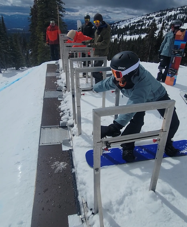 Izy getting ready to launch for a race on her snowboard