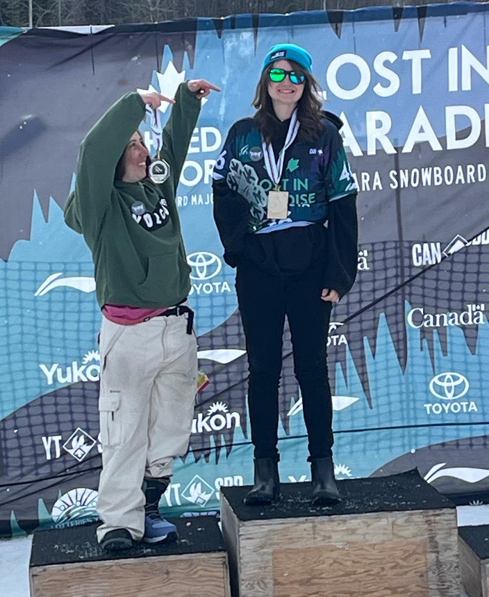 Izy standing on a victory podium